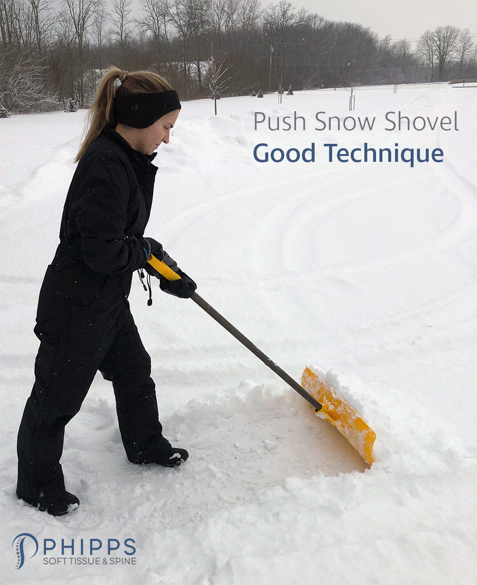 Woman demonstrates good snow shoveling technique with a push snow shovel | Phipps Soft Tissue & Spine